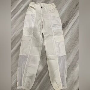 White Cargo pants w/ netting accents & zipper at ankles. Size (European size 6)